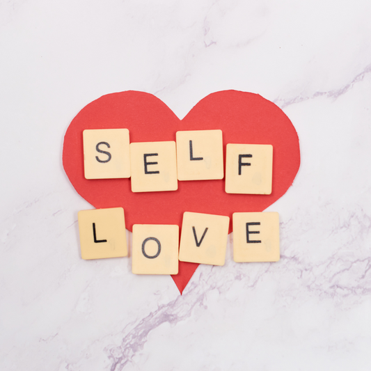 A heart with the words "Self love" written on tiles.