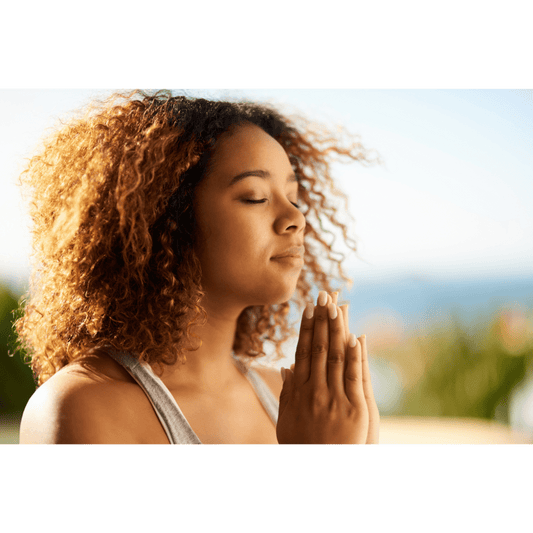 woman meditating with hands in prayer position