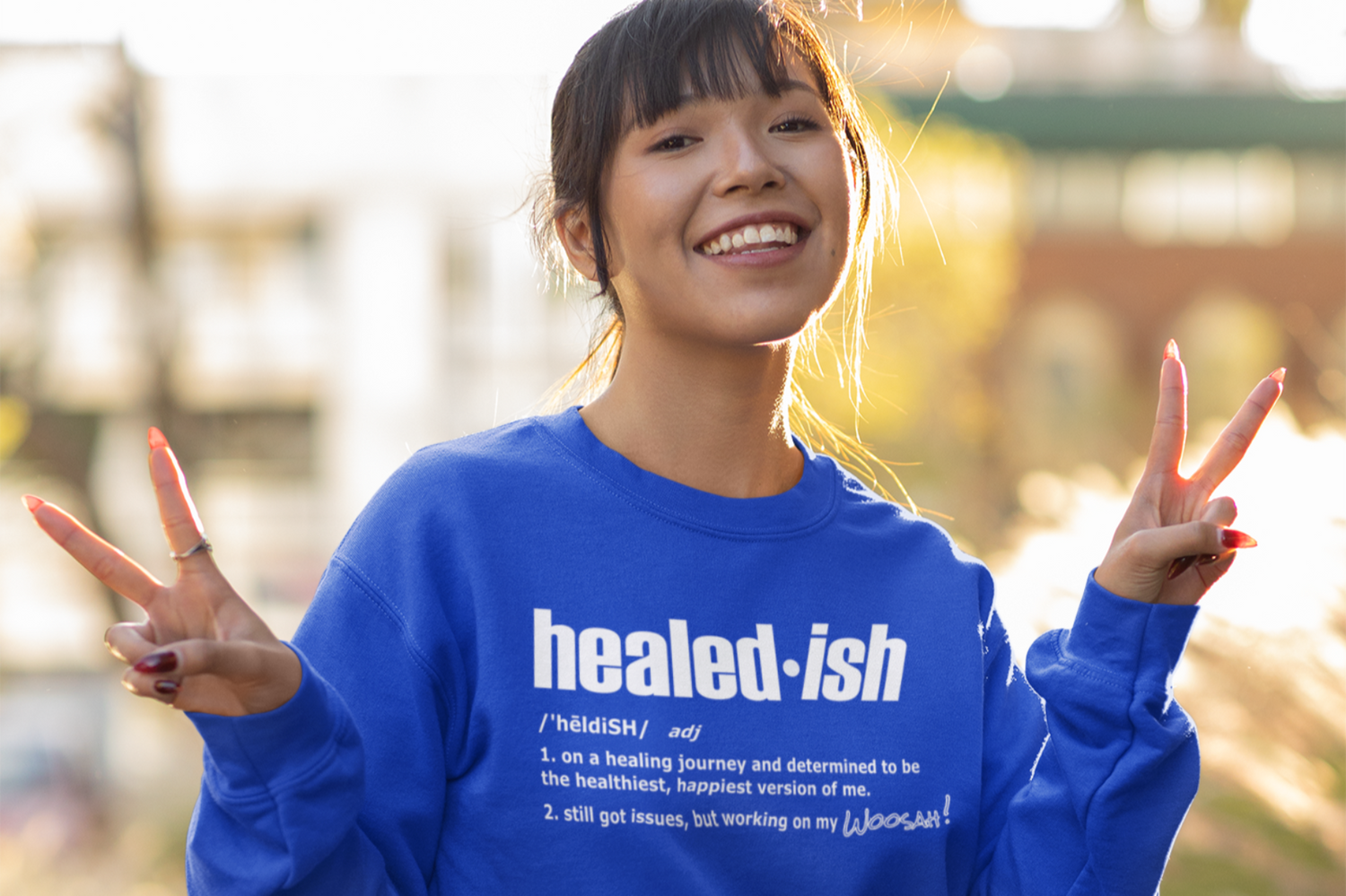 A woman wearing a blue healed-ish definition sweatshirt